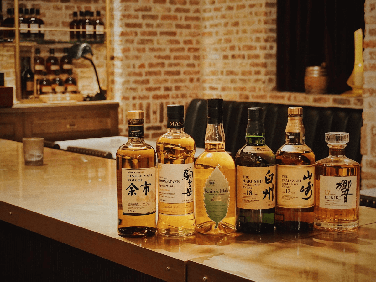 japanese whisky lined up on a bar